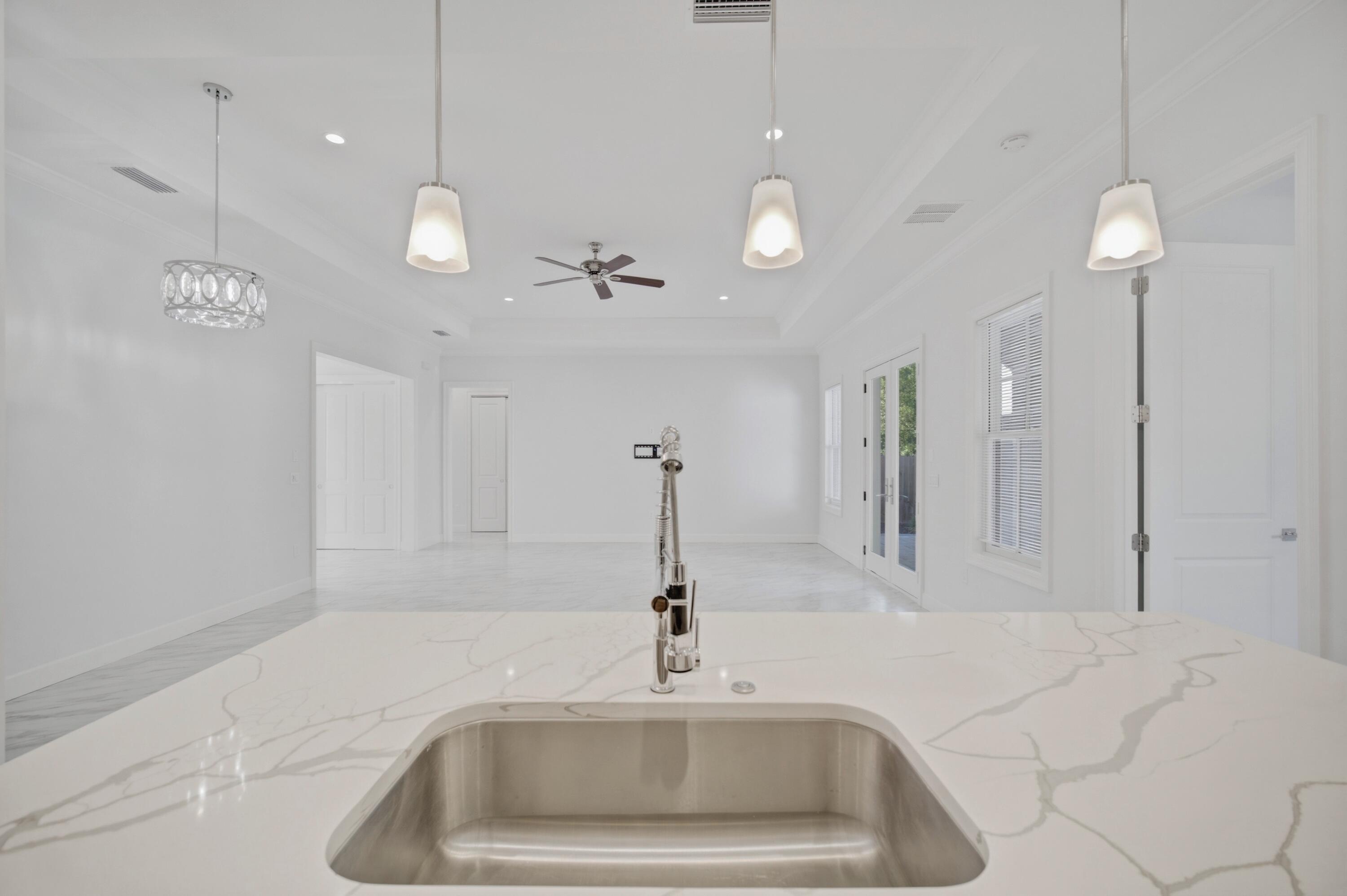 120 Lillian Way Crestview, FL 32536 - Photo 47 of 67 a kitchen with a sink and chandelier