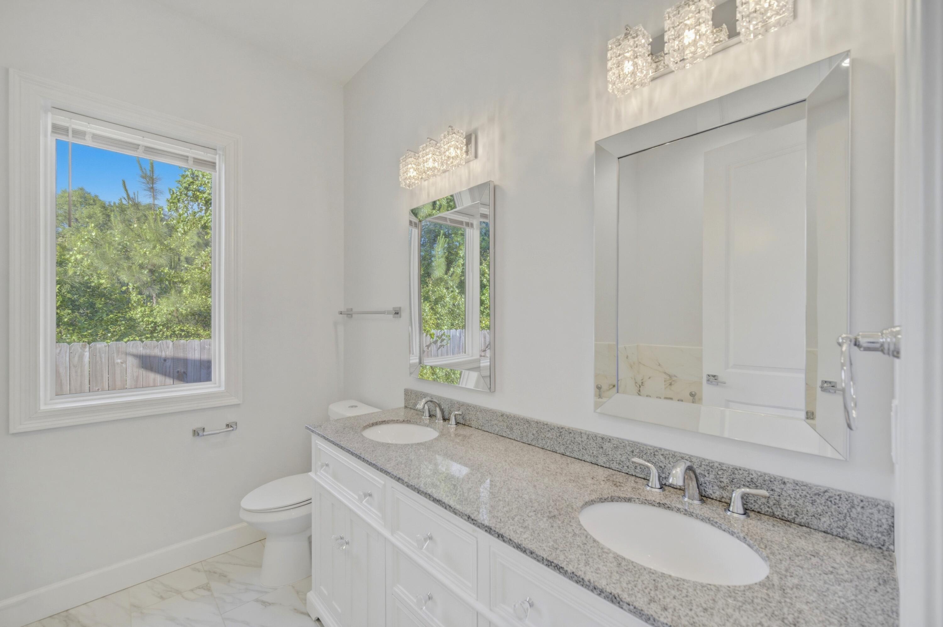 120 Lillian Way Crestview, FL 32536 - Photo 53 of 67 a bathroom with a granite countertop double vanity sink a mirror and a toilet