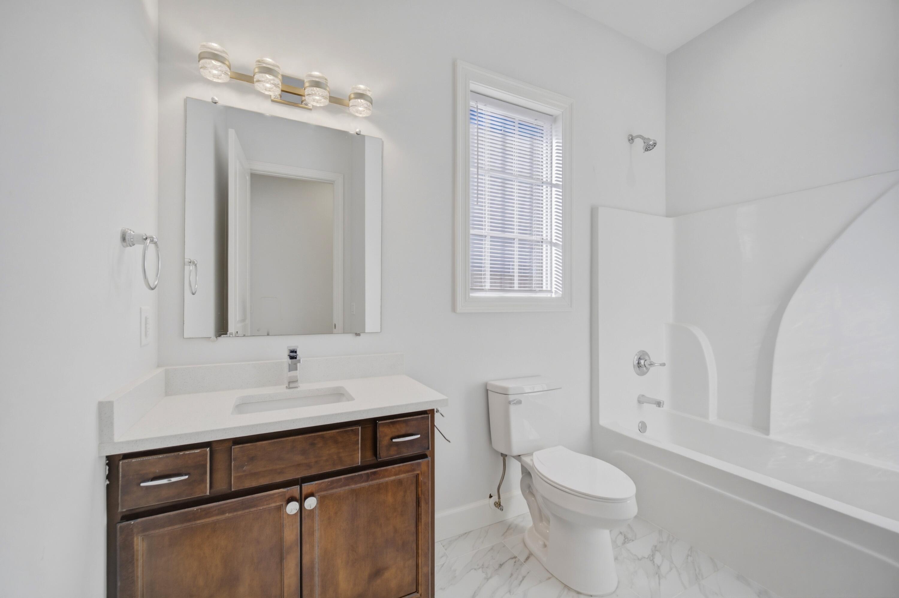 120 Lillian Way Crestview, FL 32536 - Photo 67 of 67 a bathroom with a sink vanity granite toilet and a mirror