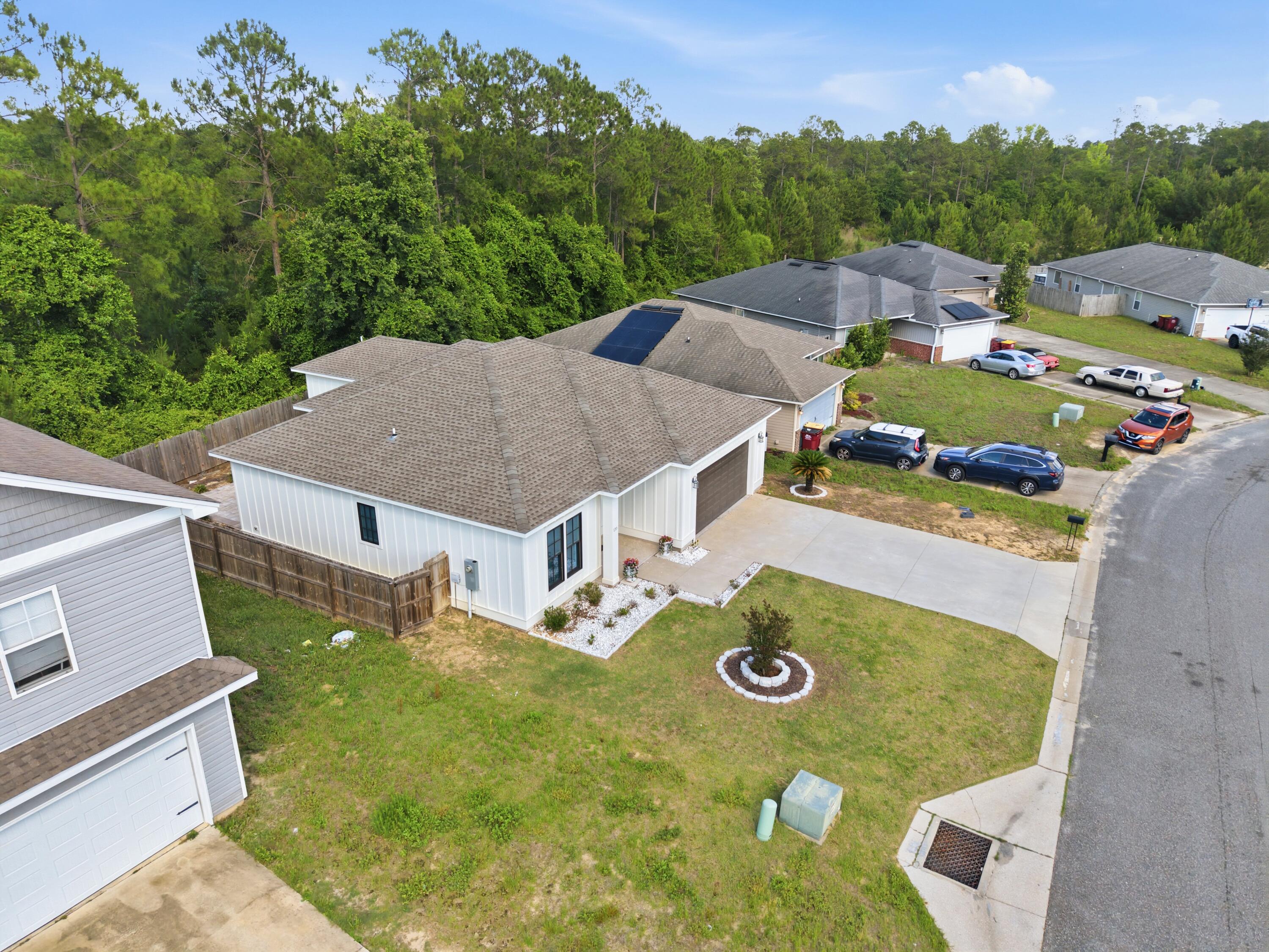 120 Lillian Way Crestview, FL 32536 - Photo 9 of 67 an aerial view of a house with swimming pool and big yard