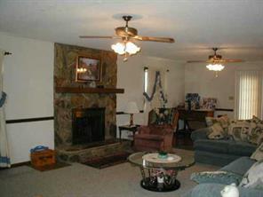 2630 Shoal Road Crouse, NC 28033 - Photo 4 of 7 a living room with furniture a chandelier and a fireplace