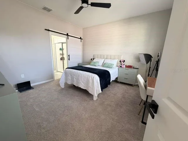 a bedroom with a bed and a couch