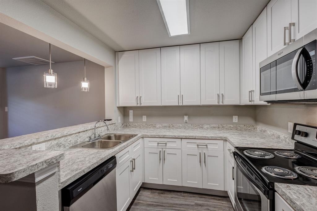 6108 Abrams Road, Unit 503 Dallas, TX 75231 - Photo 16 of 21 a kitchen with a sink stove and cabinets
