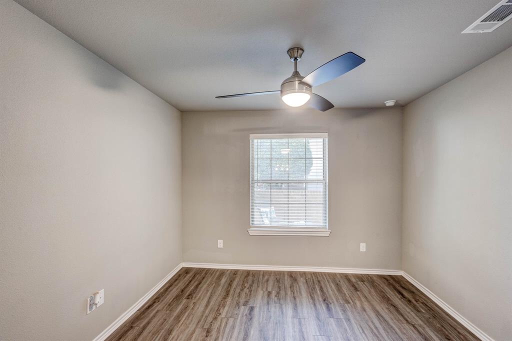 6108 Abrams Road, Unit 503 Dallas, TX 75231 - Photo 7 of 21 an empty room with wooden floor chandelier fan and windows