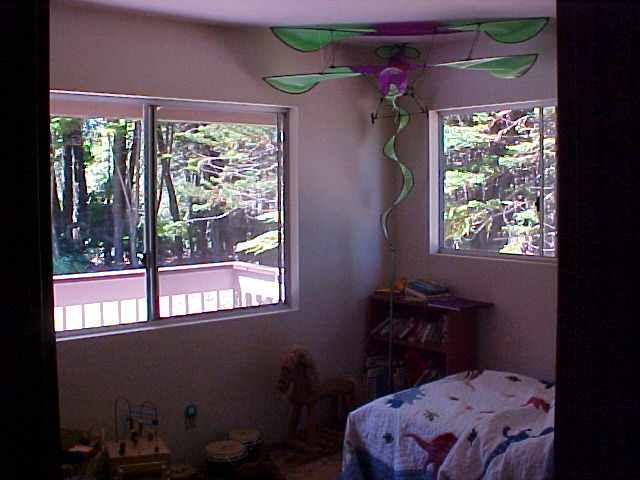 2103 Kokomo Road Haiku, HI 96708 - Photo 6 of 10 a bedroom with a bed and a window