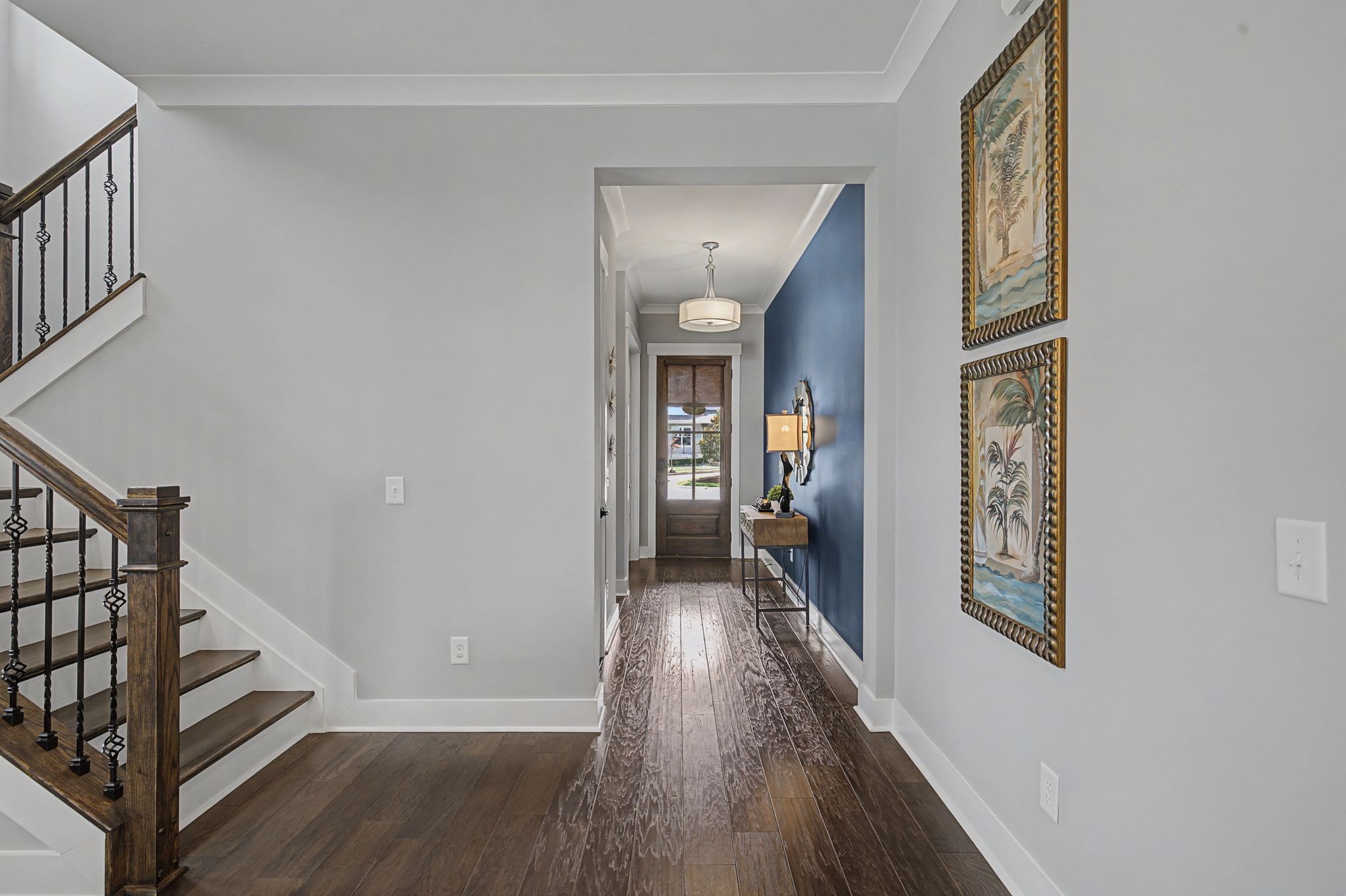 455 Cardel Lane Franklin, TN 37064 - Photo 12 of 54 a view of a hallway with wooden floor and stairs