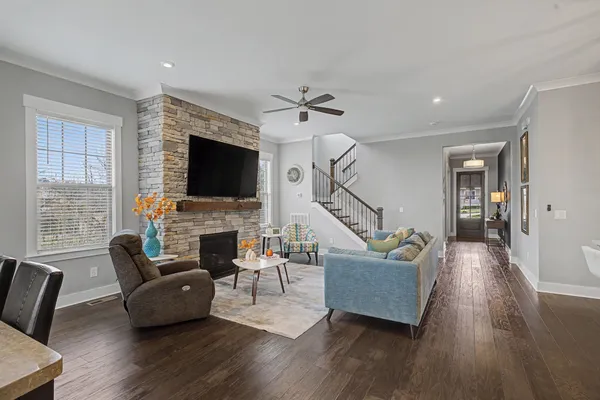 a living room with furniture and kitchen view