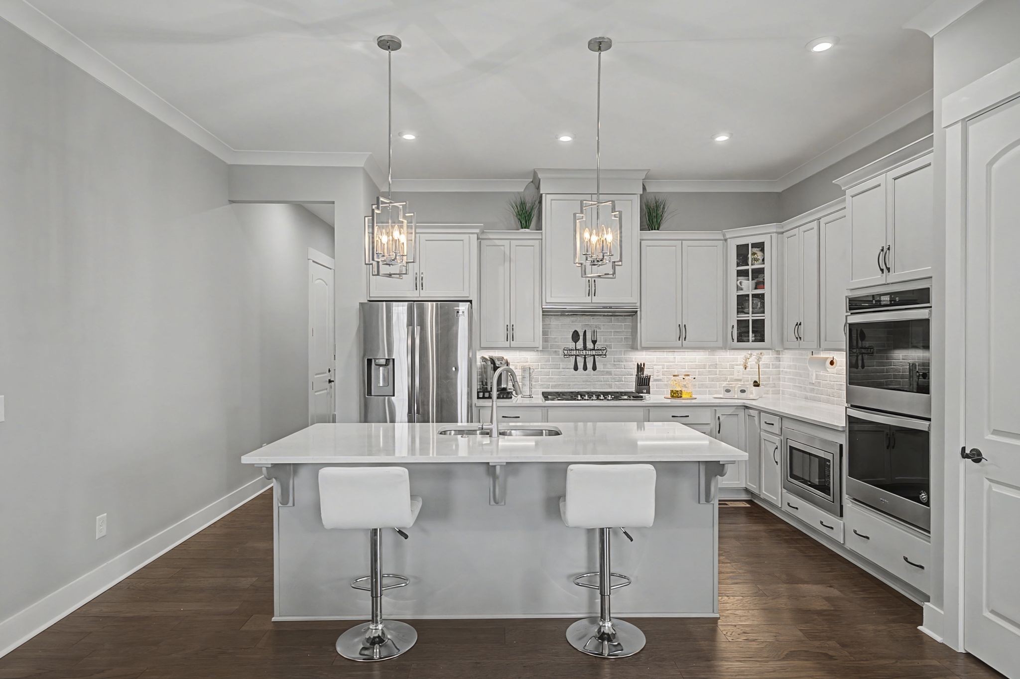 455 Cardel Lane Franklin, TN 37064 - Photo 17 of 54 a kitchen with stainless steel appliances kitchen island granite countertop a dining table chairs sink and cabinets