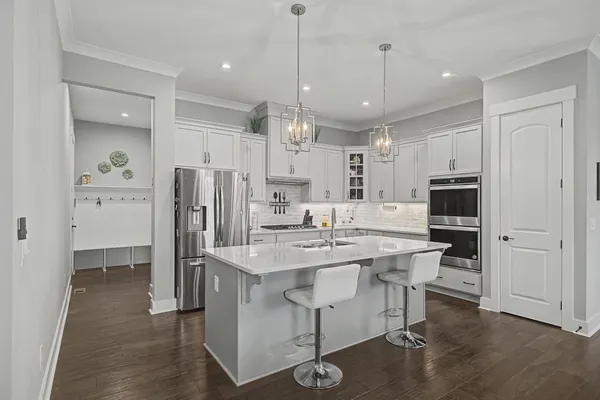 a kitchen with a sink stove and microwave
