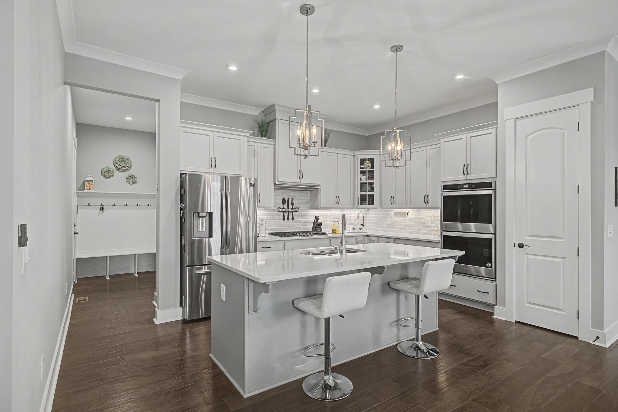 455 Cardel Lane Franklin, TN 37064 - Photo 18 of 54 a kitchen with stainless steel appliances kitchen island granite countertop a refrigerator a oven a sink and a dining table with wooden floor