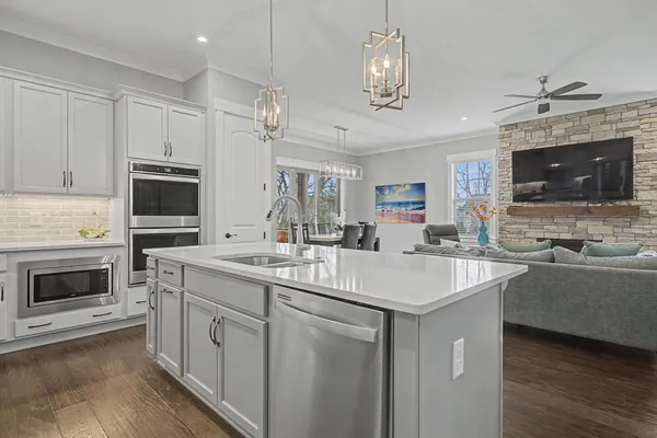 a view of living room kitchen with furniture and wooden floor