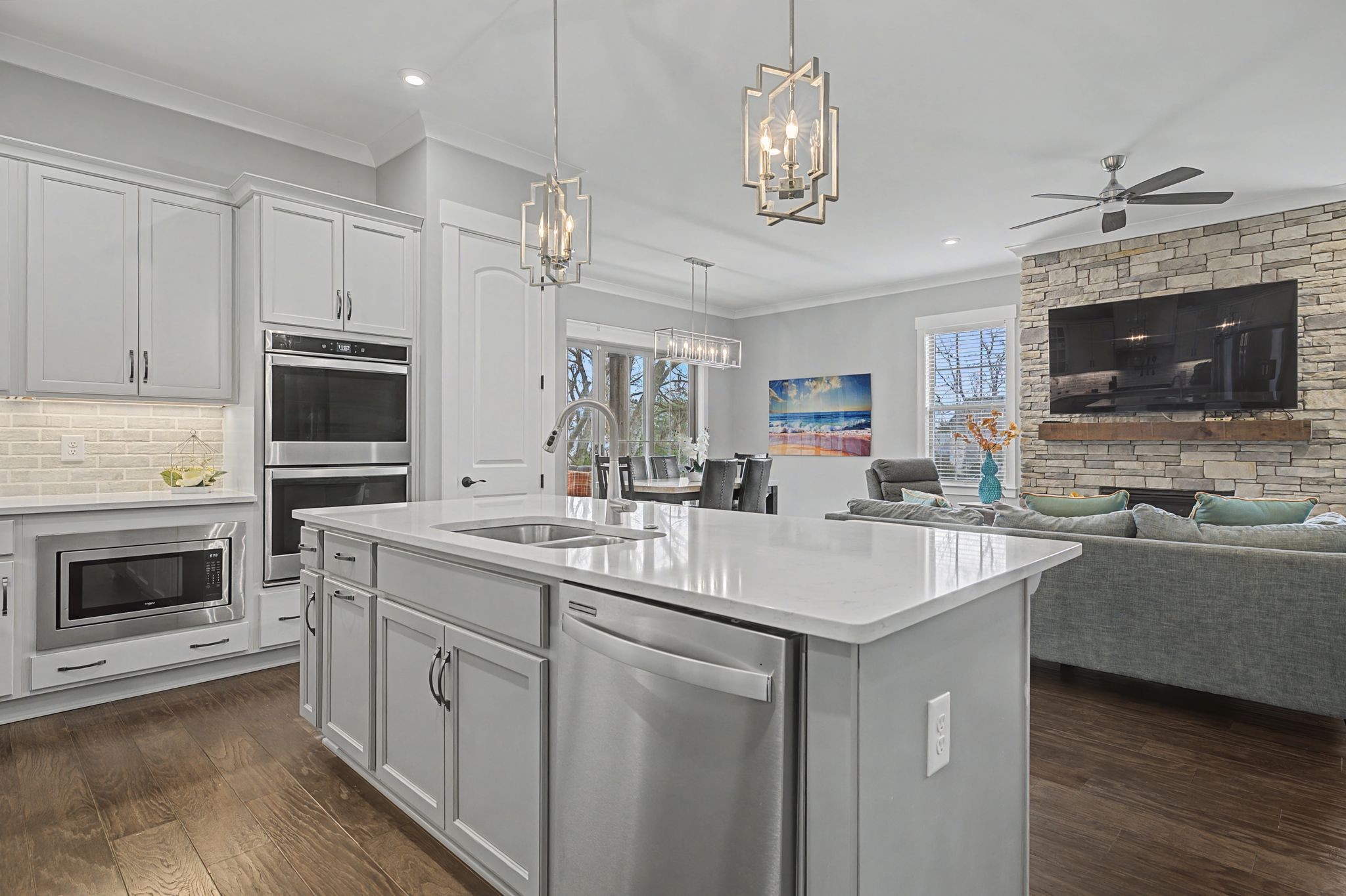 455 Cardel Lane Franklin, TN 37064 - Photo 19 of 54 a kitchen with stainless steel appliances granite countertop a stove top oven a sink dishwasher a dining table and chairs with wooden floor