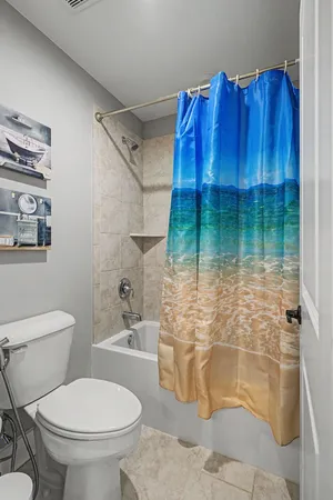 a spacious bedroom with a bed and a dresser