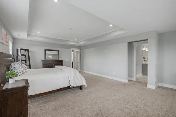 a white bath tub sitting in a bathroom next to a window