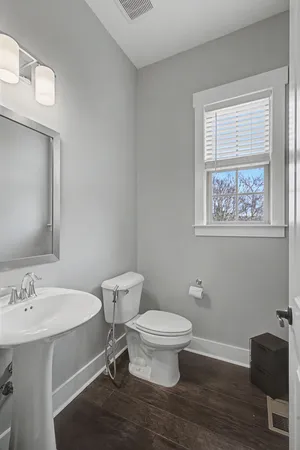 a view of a hallway with wooden floor and stairs