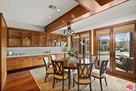 a view of a dining room with furniture large windows and wooden floor