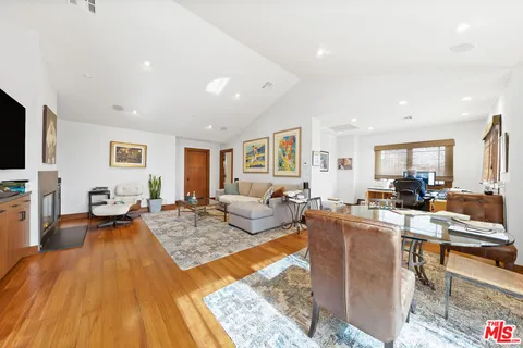 a living room with fireplace furniture and a rug