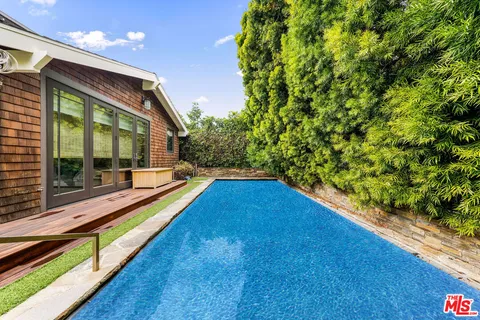 a view of swimming pool with an outdoor seating
