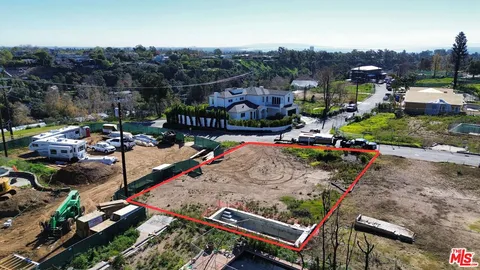 an aerial view of a fireplace with table and chairs