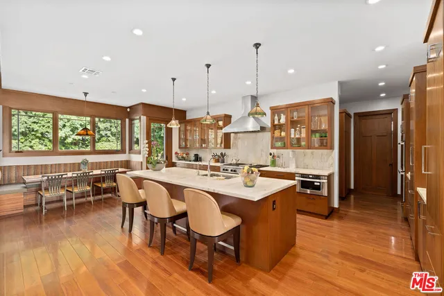 a large kitchen with lots of counter space and furniture