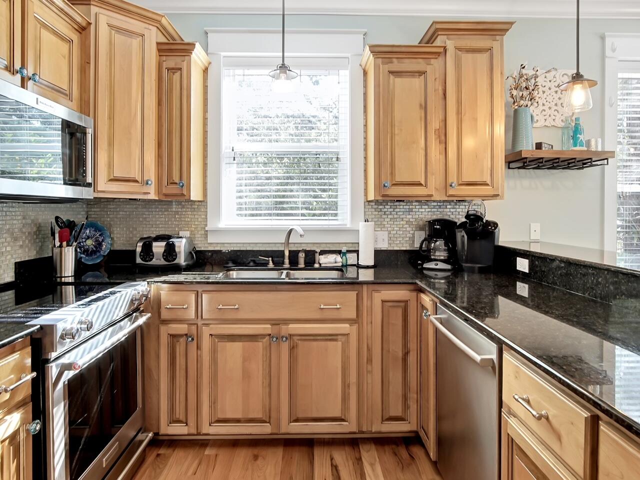212 Seacrest Beach Boulevard East Inlet Beach, FL 32461 - Photo 11 of 39 a kitchen with granite countertop a sink stainless steel appliances and cabinets