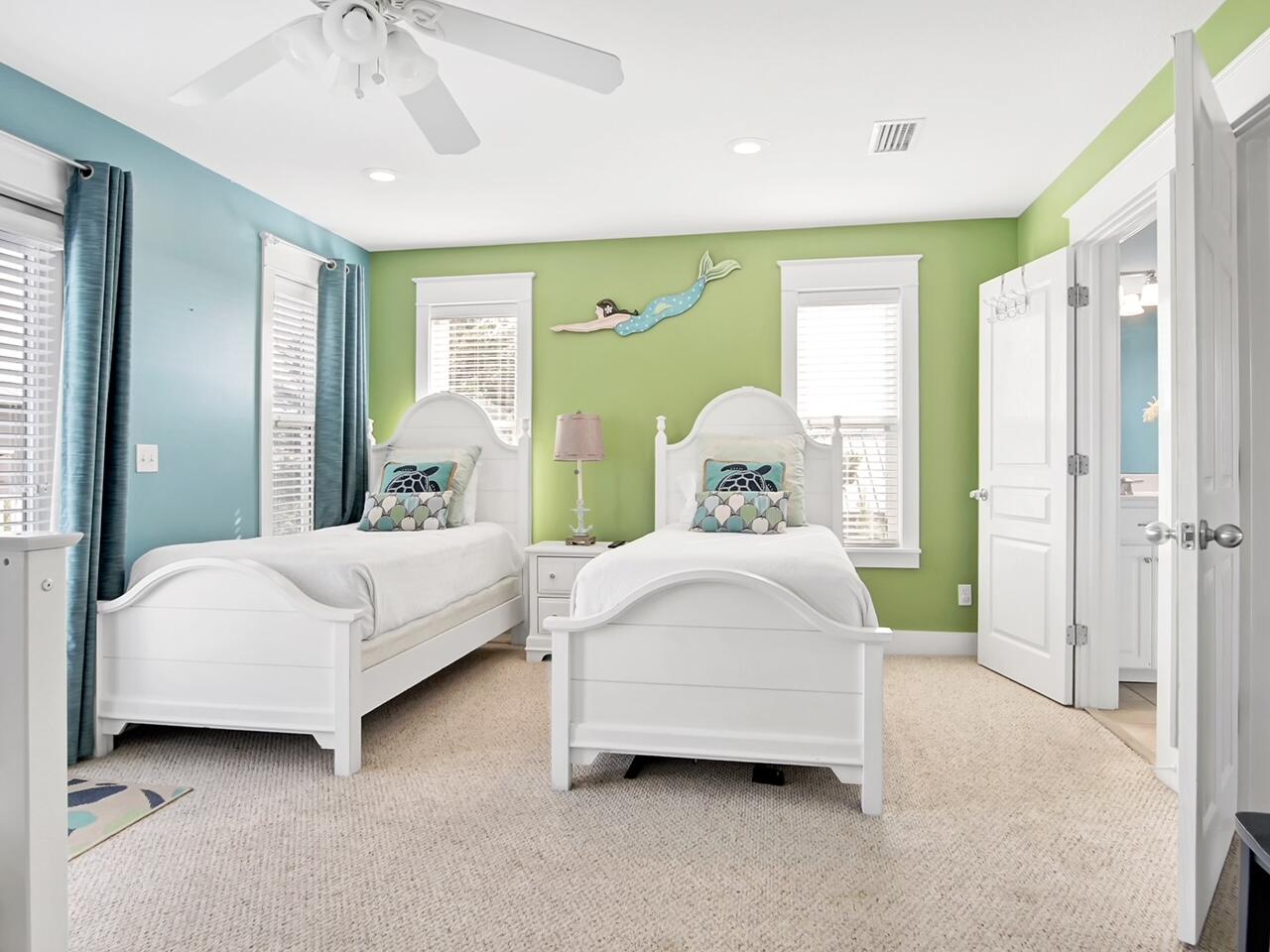 212 Seacrest Beach Boulevard East Inlet Beach, FL 32461 - Photo 23 of 39 a spacious bedroom with a bed and a chandelier