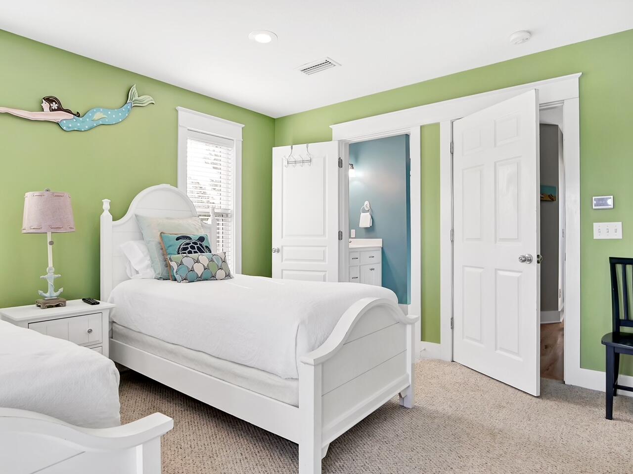 212 Seacrest Beach Boulevard East Inlet Beach, FL 32461 - Photo 24 of 39 a bedroom with a bed table and a chandelier
