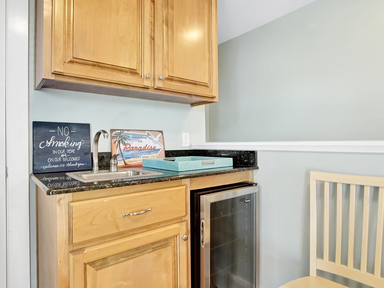 212 Seacrest Beach Boulevard East Inlet Beach, FL 32461 - Photo 30 of 39 a kitchen with stainless steel appliances granite countertop a sink and cabinets