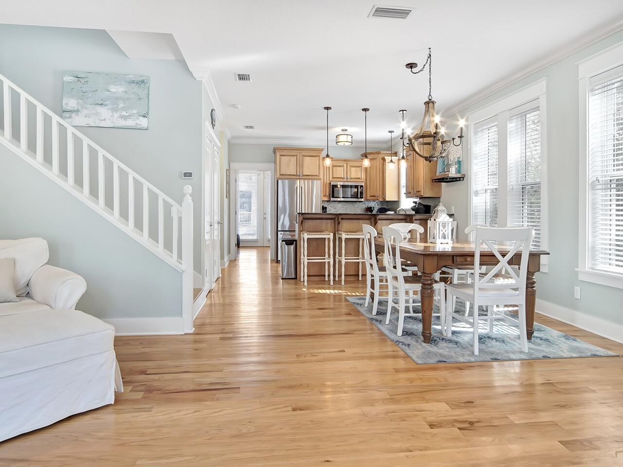 212 Seacrest Beach Boulevard East Inlet Beach, FL 32461 - Photo 7 of 39 a view of a dining room and livingroom with furniture wooden floor a chandelier