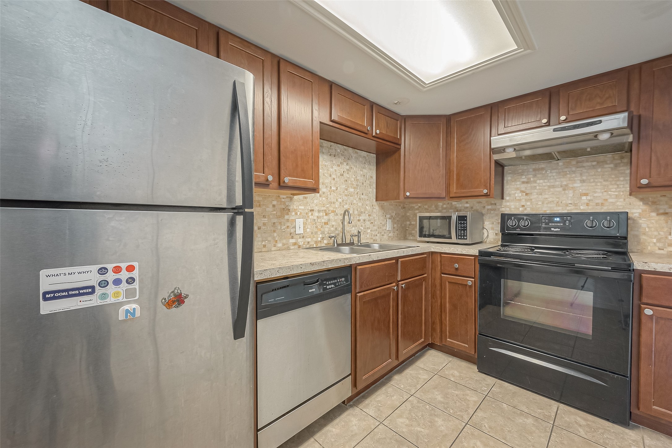 3758 Tanglewilde Street, Unit 2 Houston, TX 77063 - Photo 12 of 28 a kitchen with stainless steel appliances granite countertop a refrigerator sink and stove