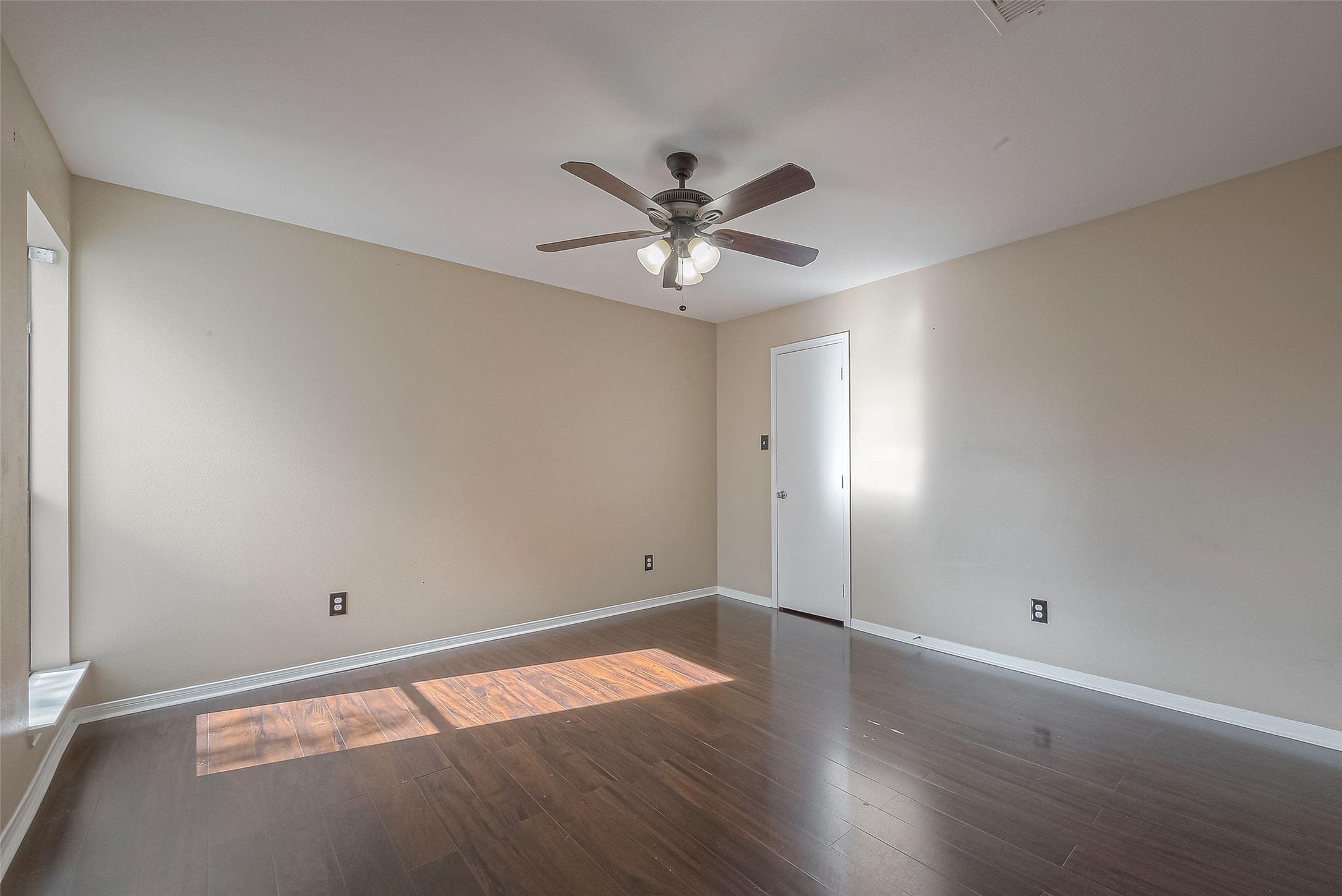 3758 Tanglewilde Street, Unit 2 Houston, TX 77063 - Photo 16 of 28 wooden floor in an empty room with a window