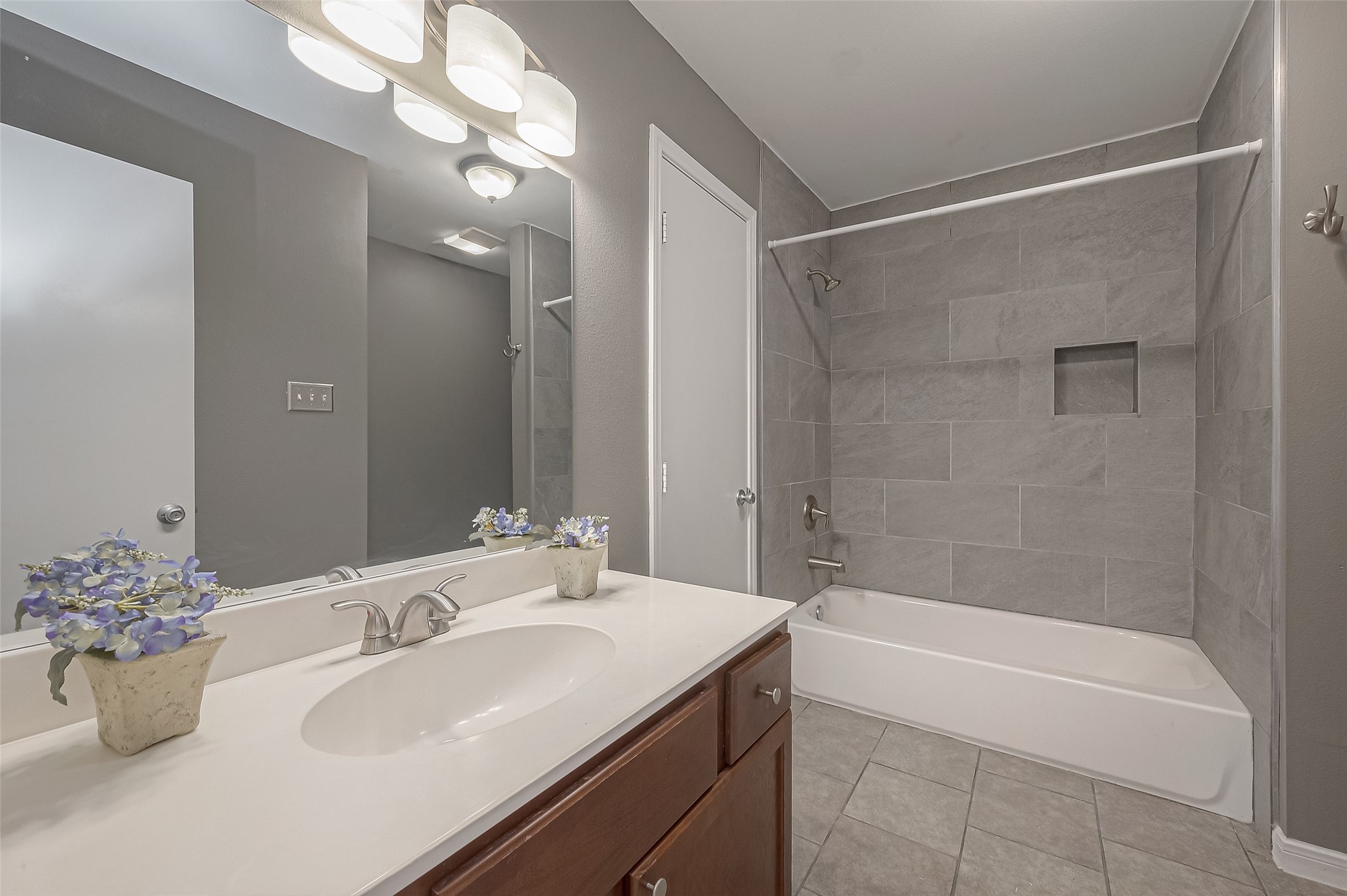 3758 Tanglewilde Street, Unit 2 Houston, TX 77063 - Photo 20 of 28 a bathroom with a tub sink and mirror