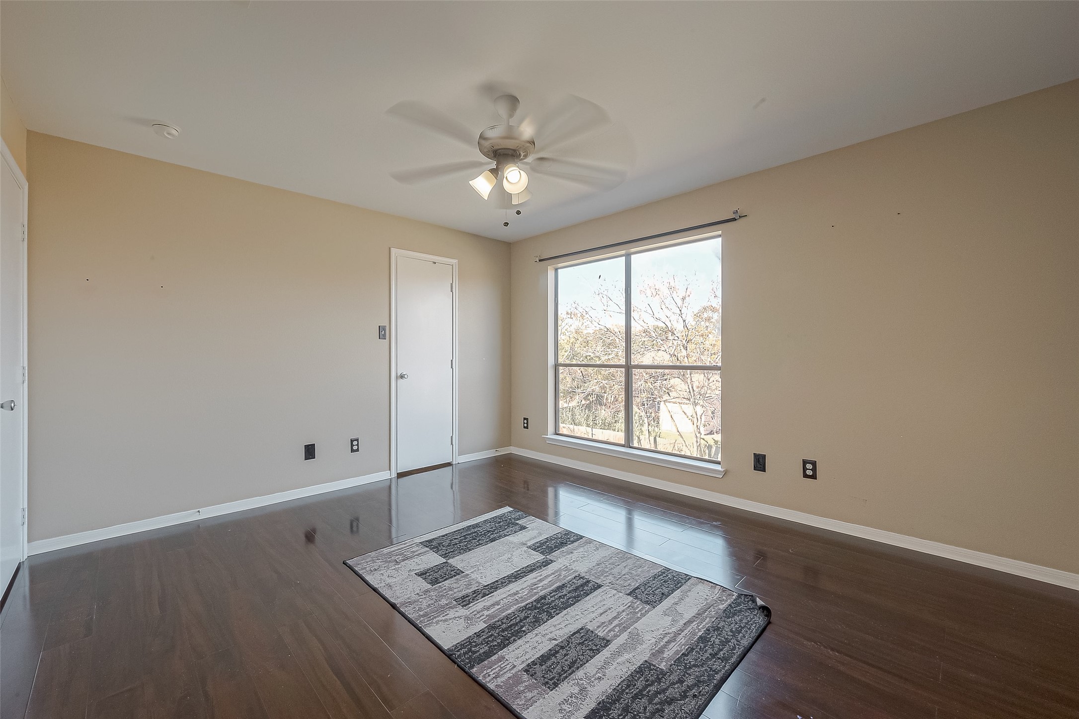 3758 Tanglewilde Street, Unit 2 Houston, TX 77063 - Photo 23 of 28 a view of an empty room with a window and wooden floor