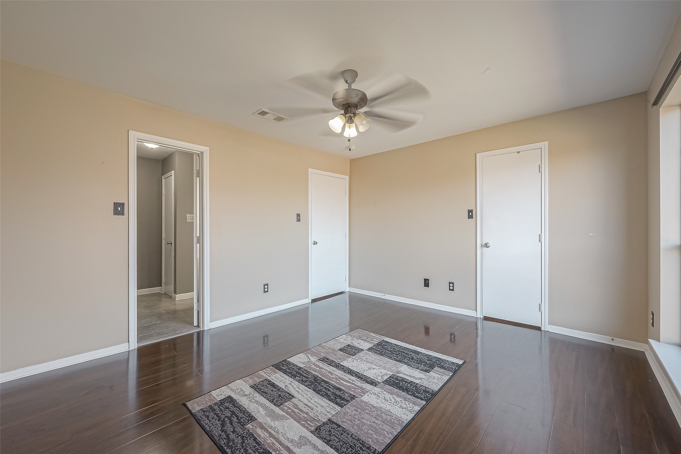 3758 Tanglewilde Street, Unit 2 Houston, TX 77063 - Photo 24 of 28 wooden floor in an empty room with a window