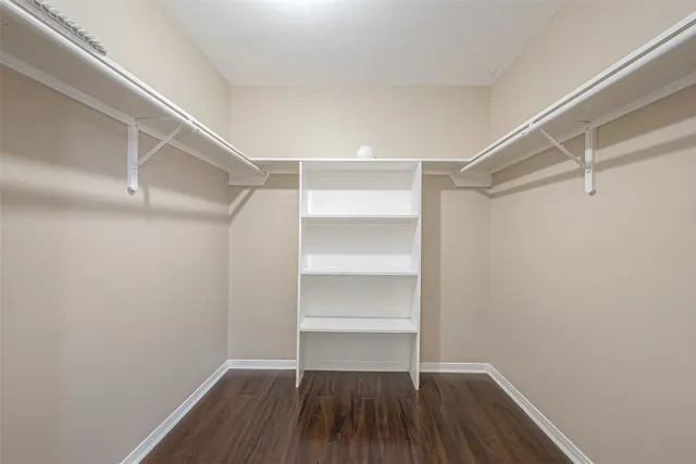a view of walk in closet with empty racks