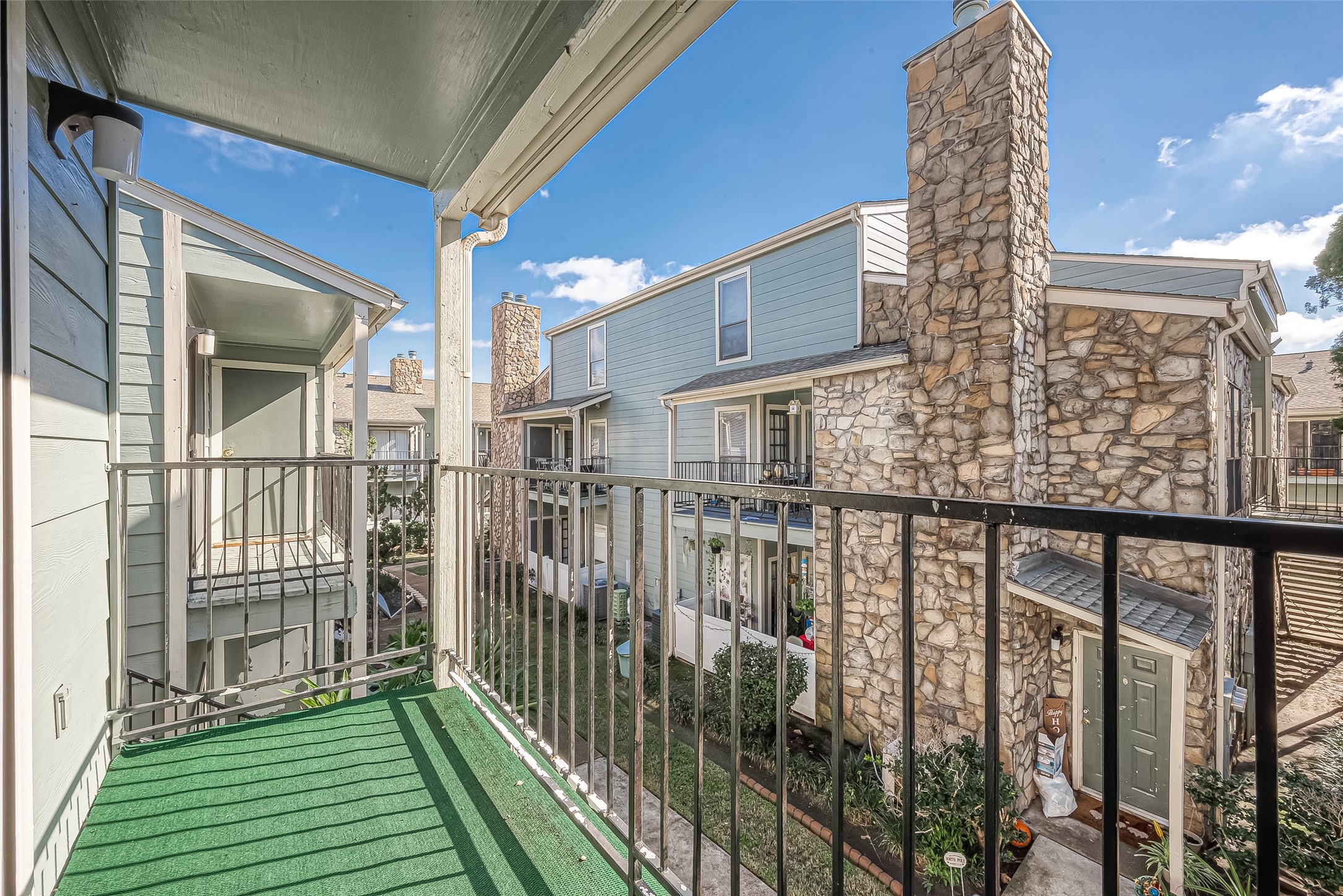 3758 Tanglewilde Street, Unit 2 Houston, TX 77063 - Photo 26 of 28 a view of a brick building from a balcony