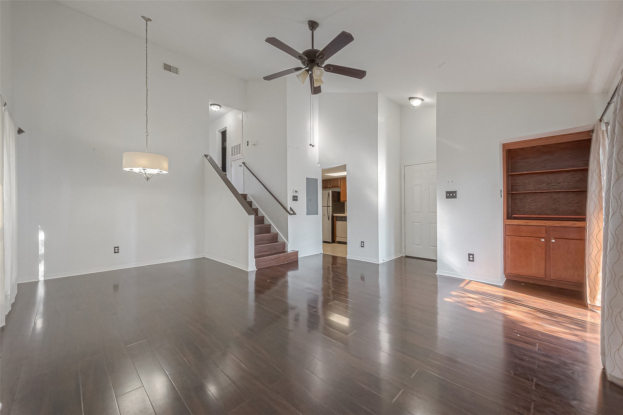 3758 Tanglewilde Street, Unit 2 Houston, TX 77063 - Photo 4 of 28 a view of an empty room with wooden floor and a ceiling fan