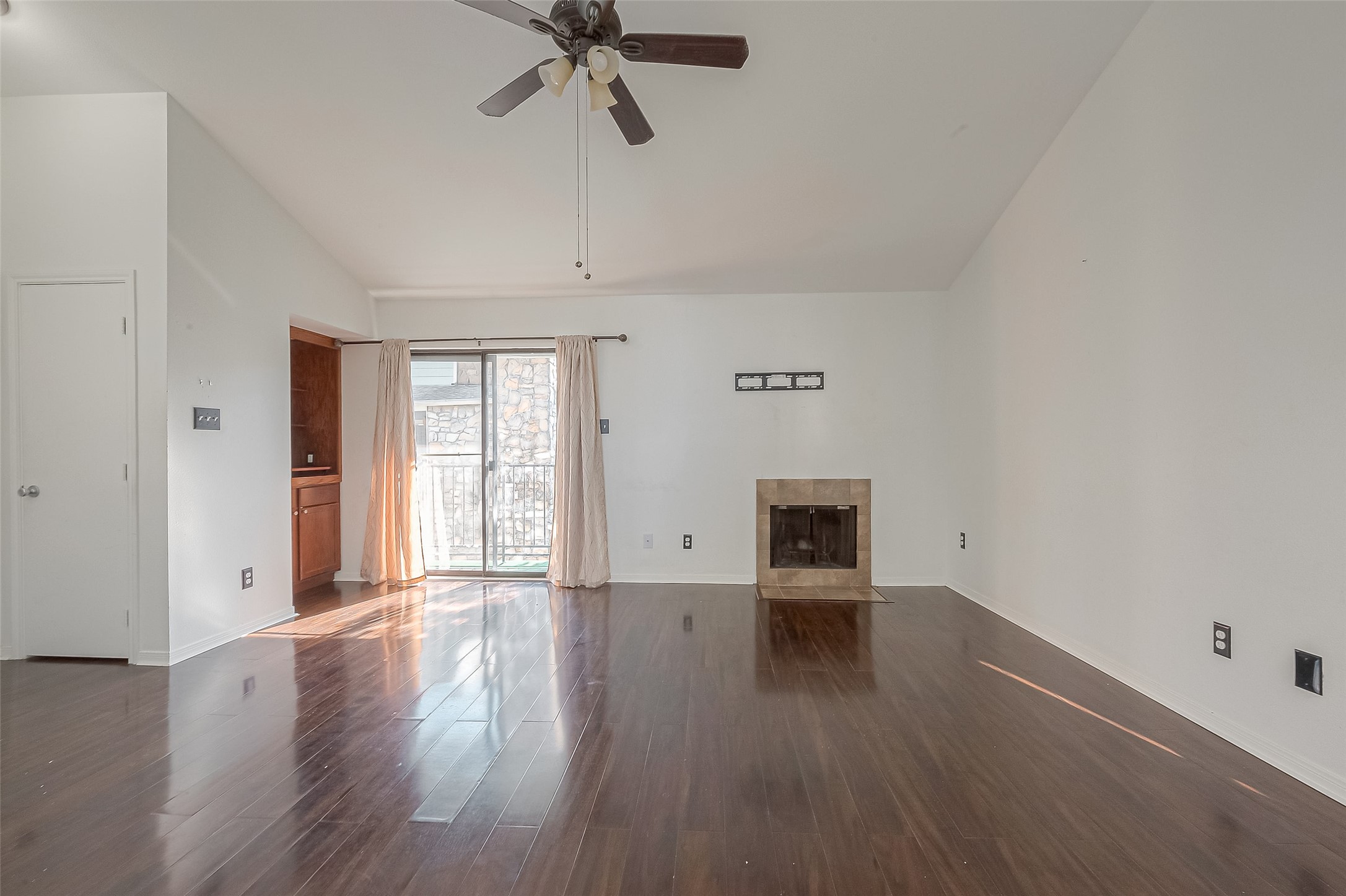 3758 Tanglewilde Street, Unit 2 Houston, TX 77063 - Photo 7 of 28 a view of an empty room with a window and wooden floor