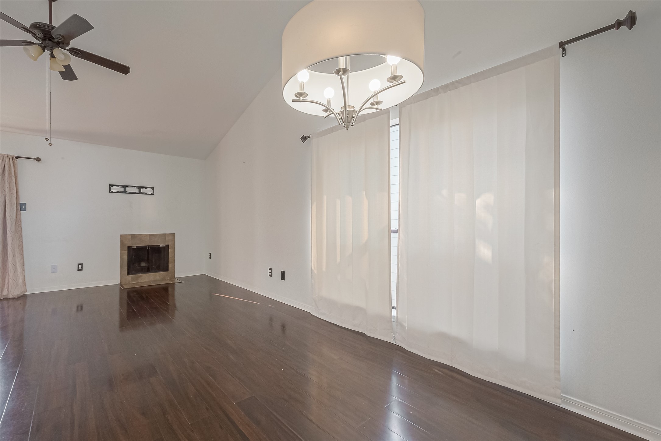 3758 Tanglewilde Street, Unit 2 Houston, TX 77063 - Photo 9 of 28 an empty room with wooden floor mirror and windows