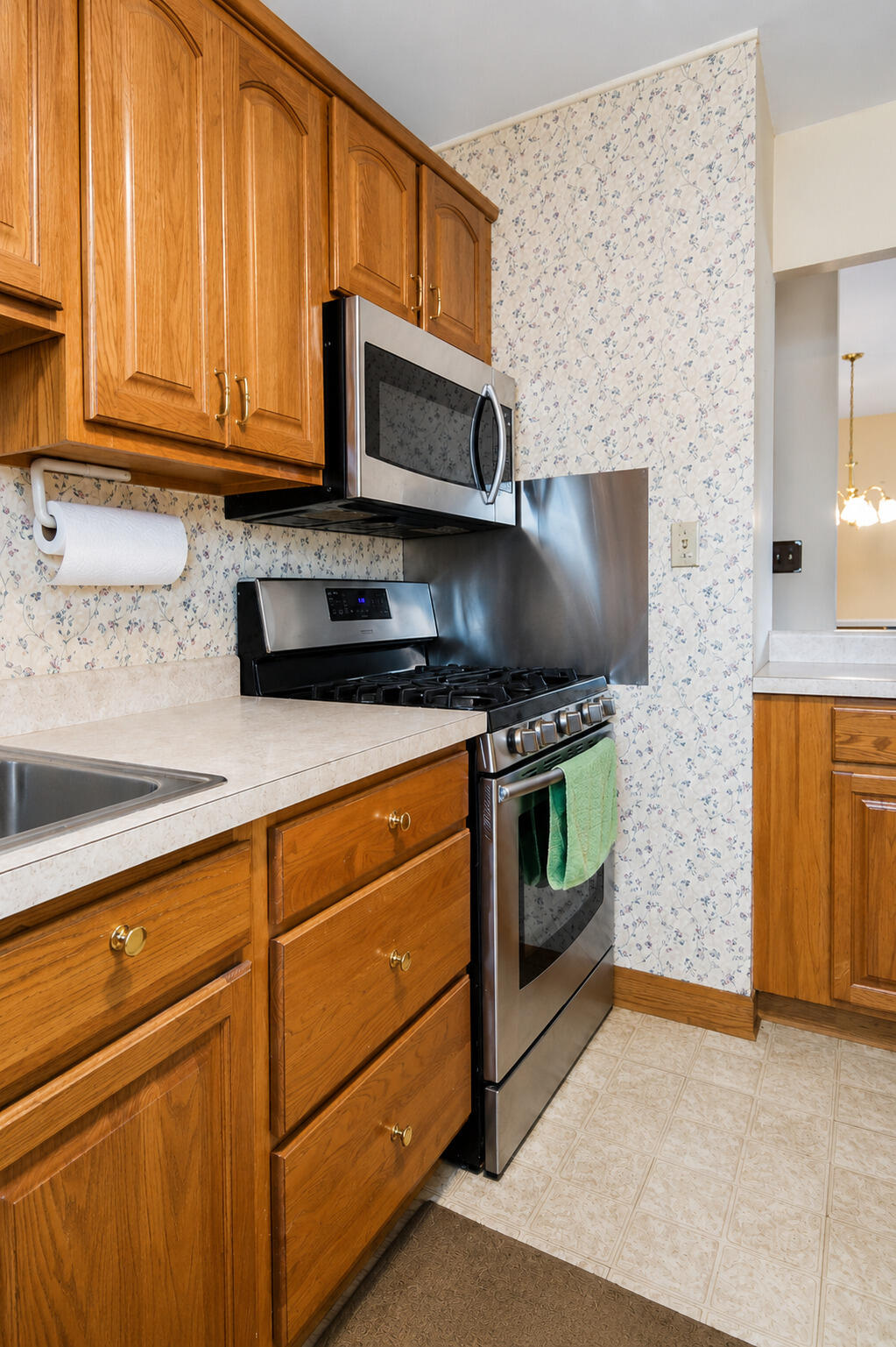 9502 Forrest Drive Highland, IN 46322 - Photo 11 of 27 a kitchen with stainless steel appliances granite countertop a stove microwave and cabinets