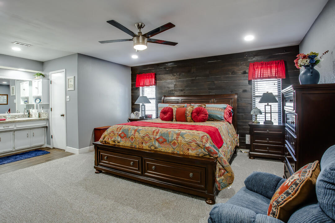 5304 89th Street Lubbock, TX 79424 - Photo 11 of 21 a bed room with a bed and a television