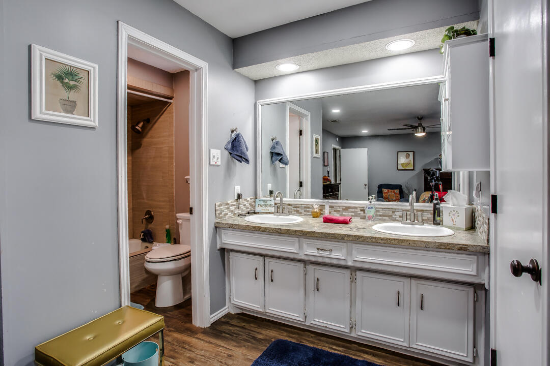5304 89th Street Lubbock, TX 79424 - Photo 12 of 21 a bathroom with a toilet sink and mirror