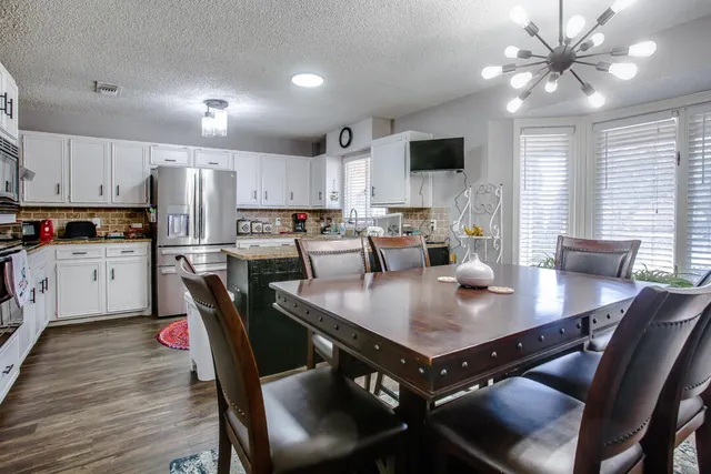a view of kitchen with cabinets table and chairs