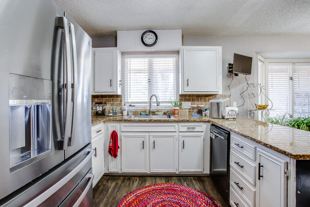5304 89th Street Lubbock, TX 79424 - Photo 8 of 21 a kitchen with stainless steel appliances granite countertop a sink cabinets and window