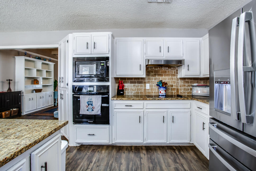 5304 89th Street Lubbock, TX 79424 - Photo 9 of 21 a kitchen with stainless steel appliances granite countertop a stove and cabinets