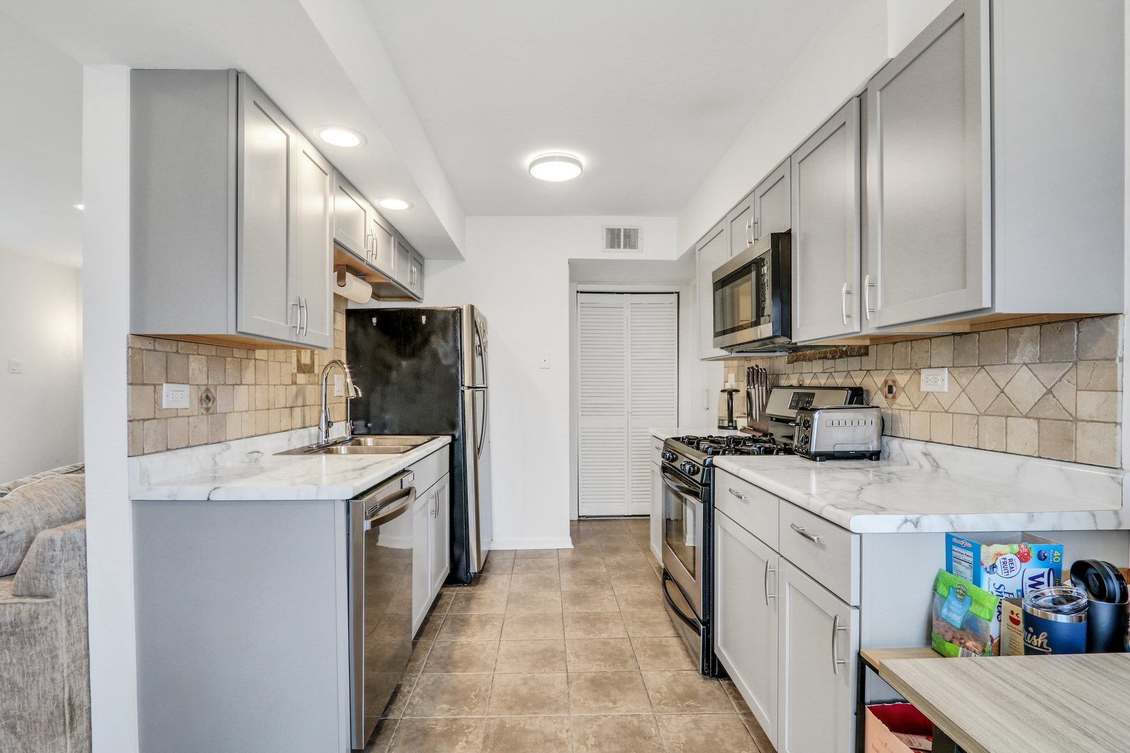 655 Hale Court Wheeling, IL 60090 - Photo 7 of 19 a kitchen with stainless steel appliances granite countertop a sink stove refrigerator and cabinets