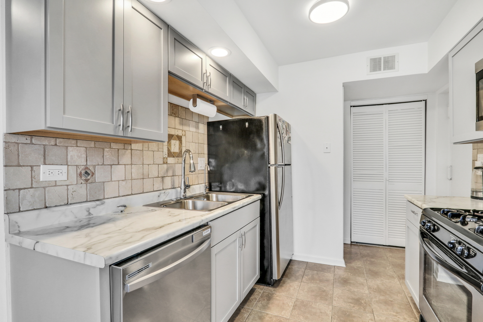 655 Hale Court Wheeling, IL 60090 - Photo 9 of 19 a kitchen with stainless steel appliances granite countertop a sink stove and refrigerator