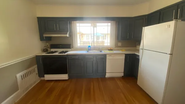 a kitchen with a sink a refrigerator and window