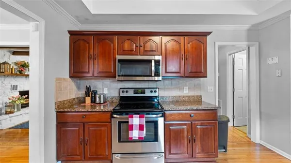 a kitchen with stainless steel appliances granite countertop a refrigerator and a sink