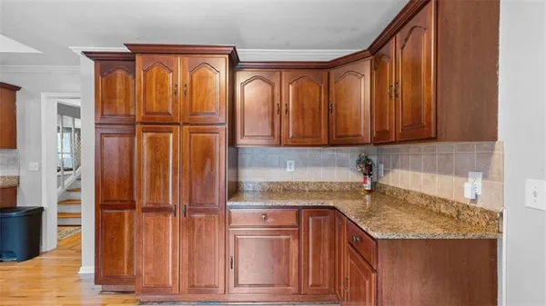 a kitchen with a refrigerator sink dining table and chairs